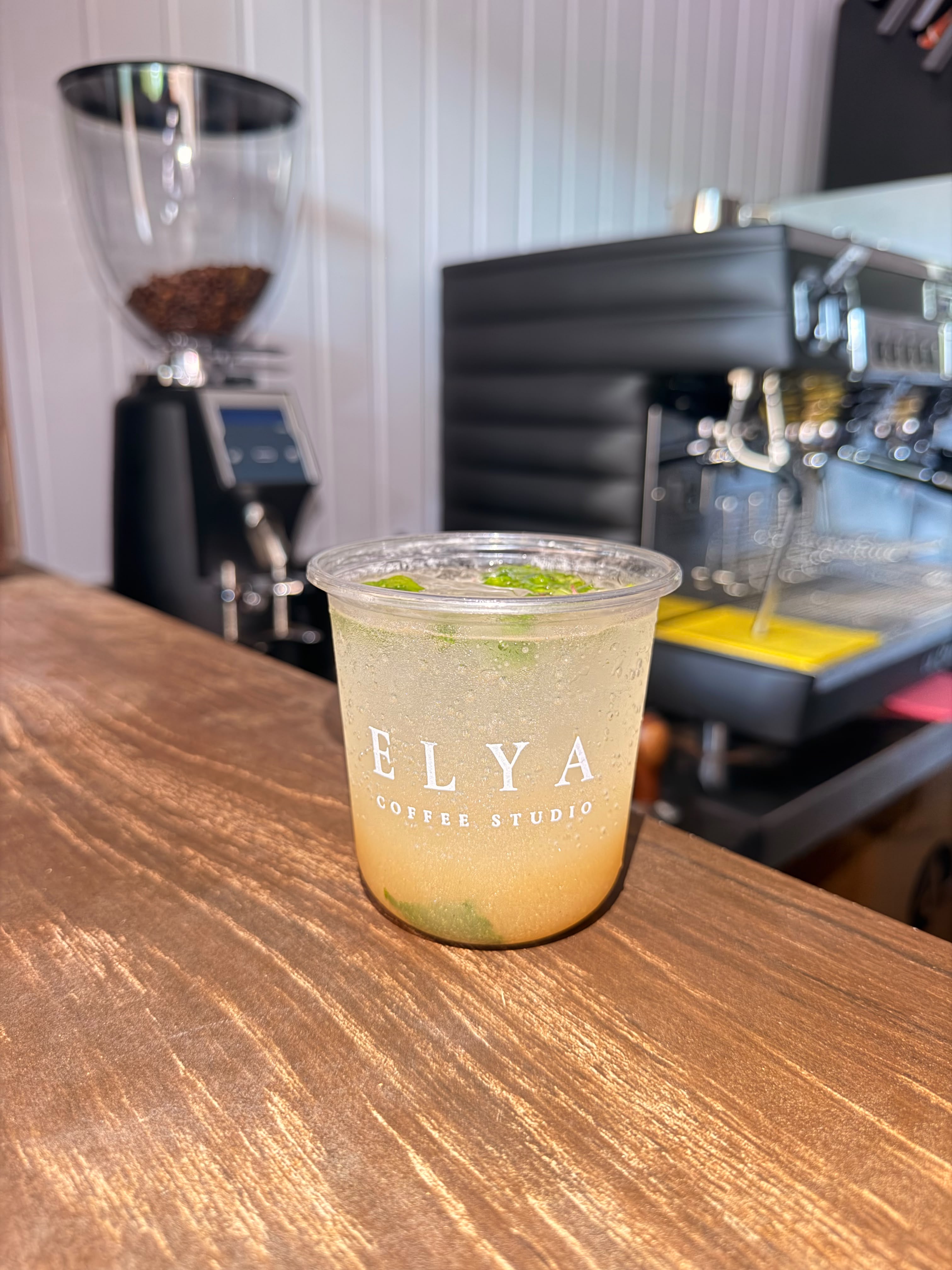 A chilled mojito in an ELYA cup on the walnut counter